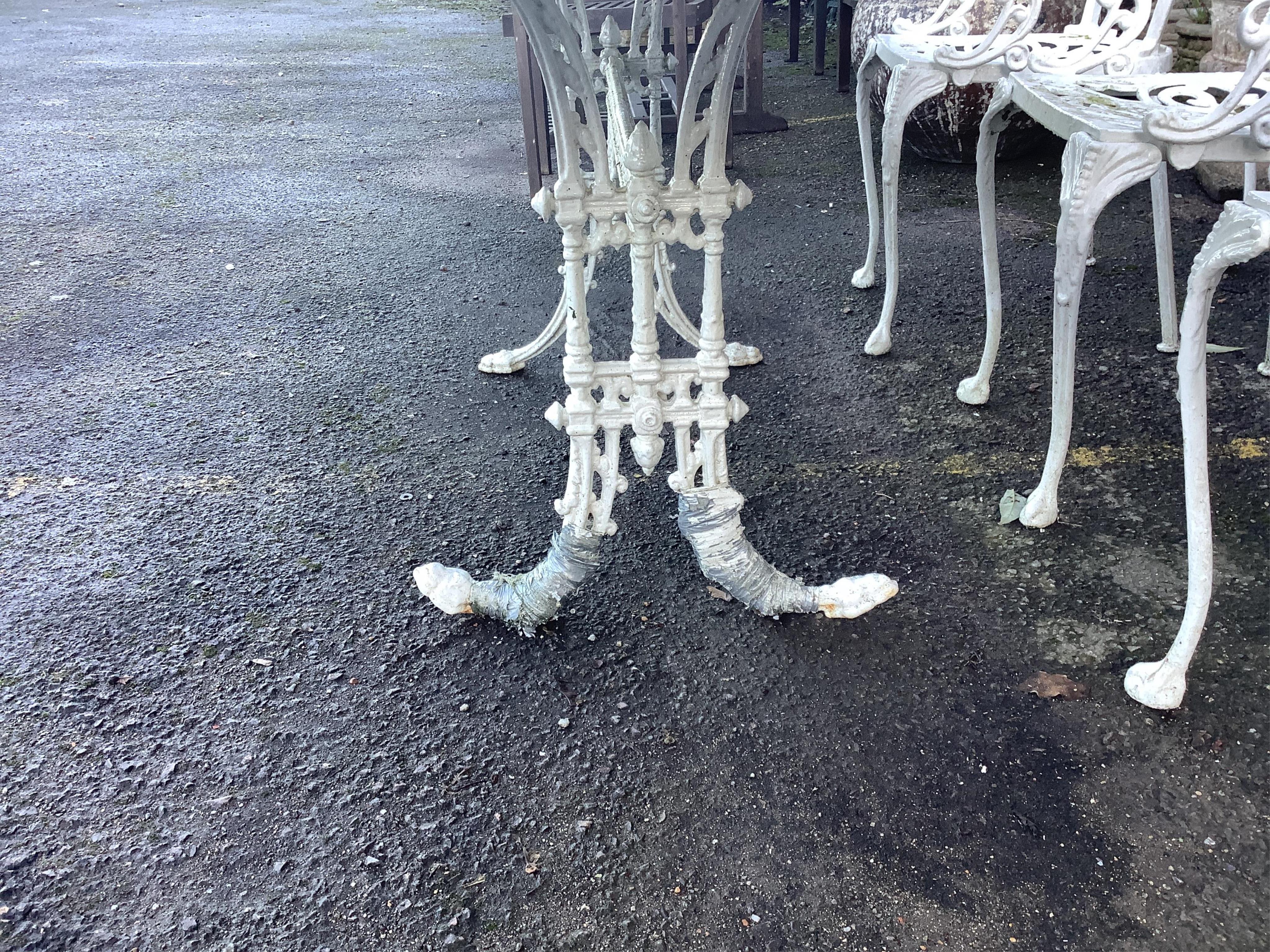 A white painted cast aluminium garden table, width 183cm, depth 92cm, height 71cm, and six chairs. Condition - fair